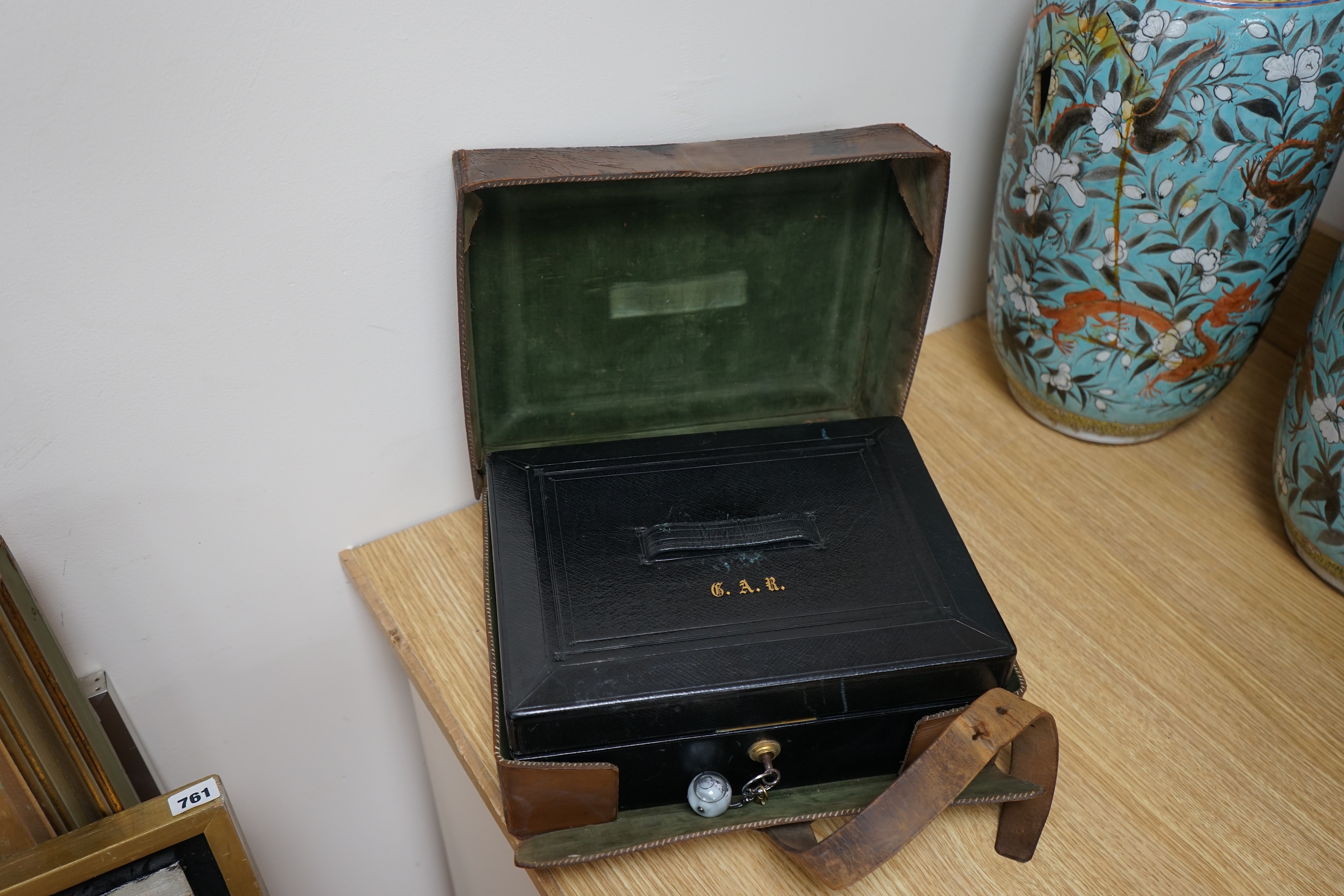 Wells & Lambert, London, a travelling writing box and outer leather case, with Bramah lock and keys, with monograms and inscriptions of Rev. George A. Robins, the box incorporating a silver lidded inkwell, 33cm wide. Con